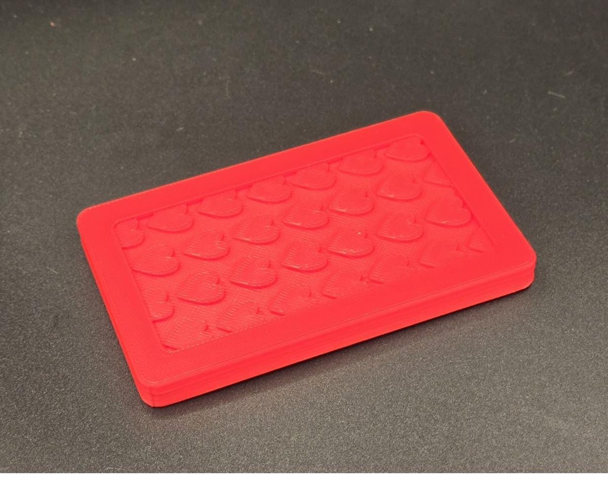 Red 3D printed mini tote lid with textured grip top, angled view