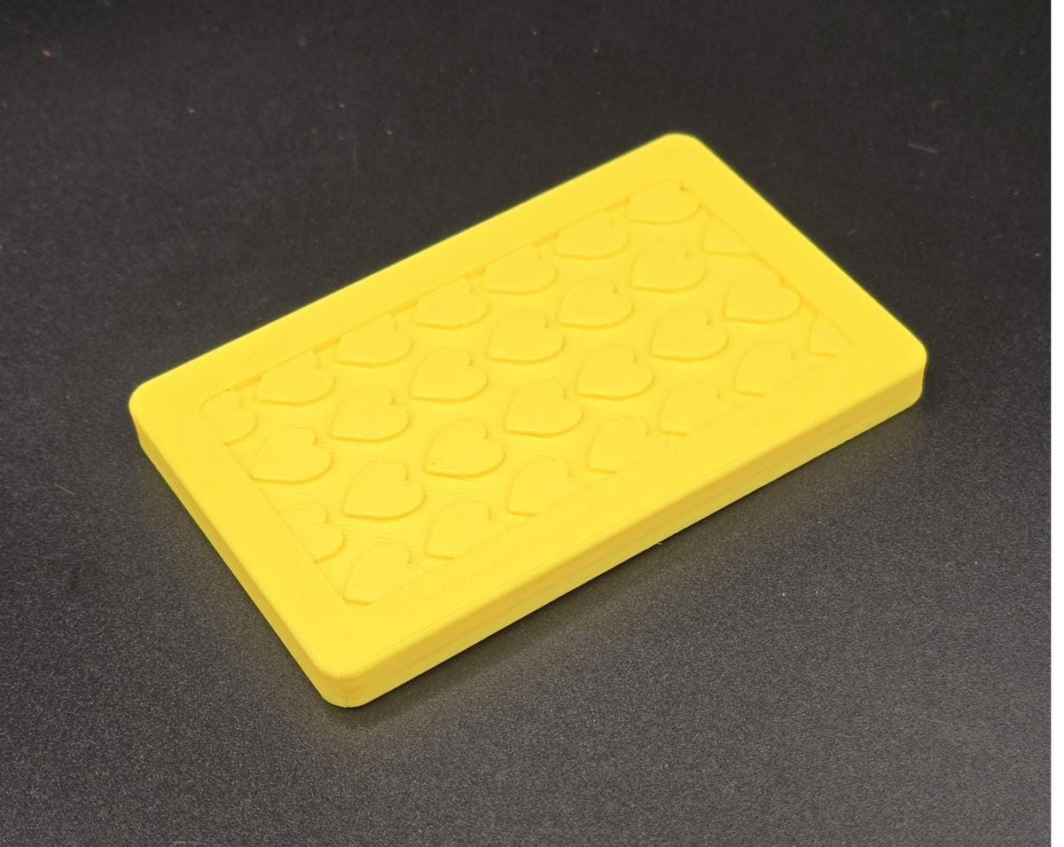 Yellow 3D printed mini tote lid with textured grip top, angled view