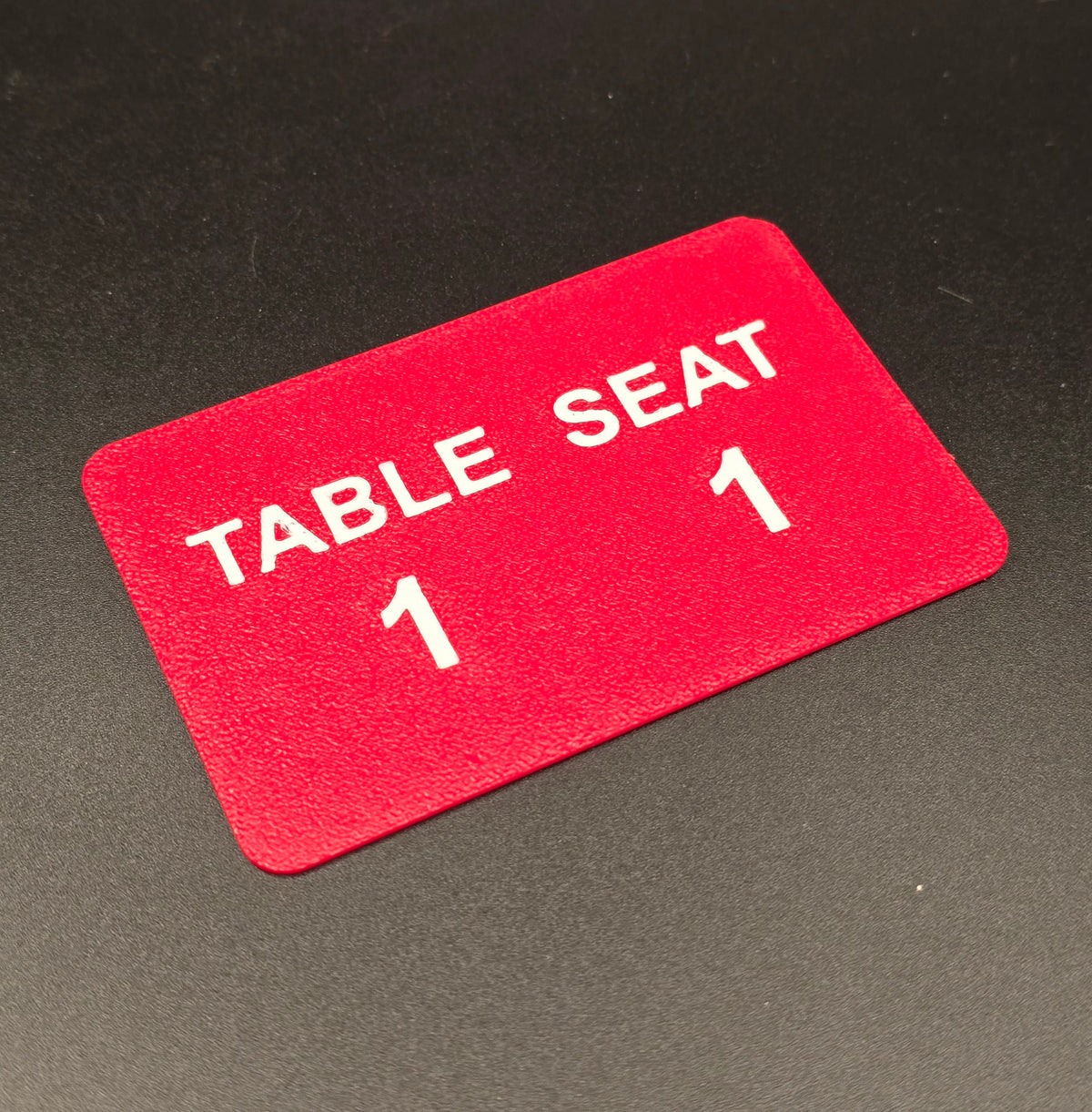 Single poker seat card, Table 1 Seat 1, 3D printed in maroon